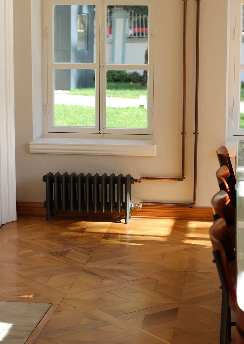Peaceful sunlit interior featuring radiator under, hardwood flooring