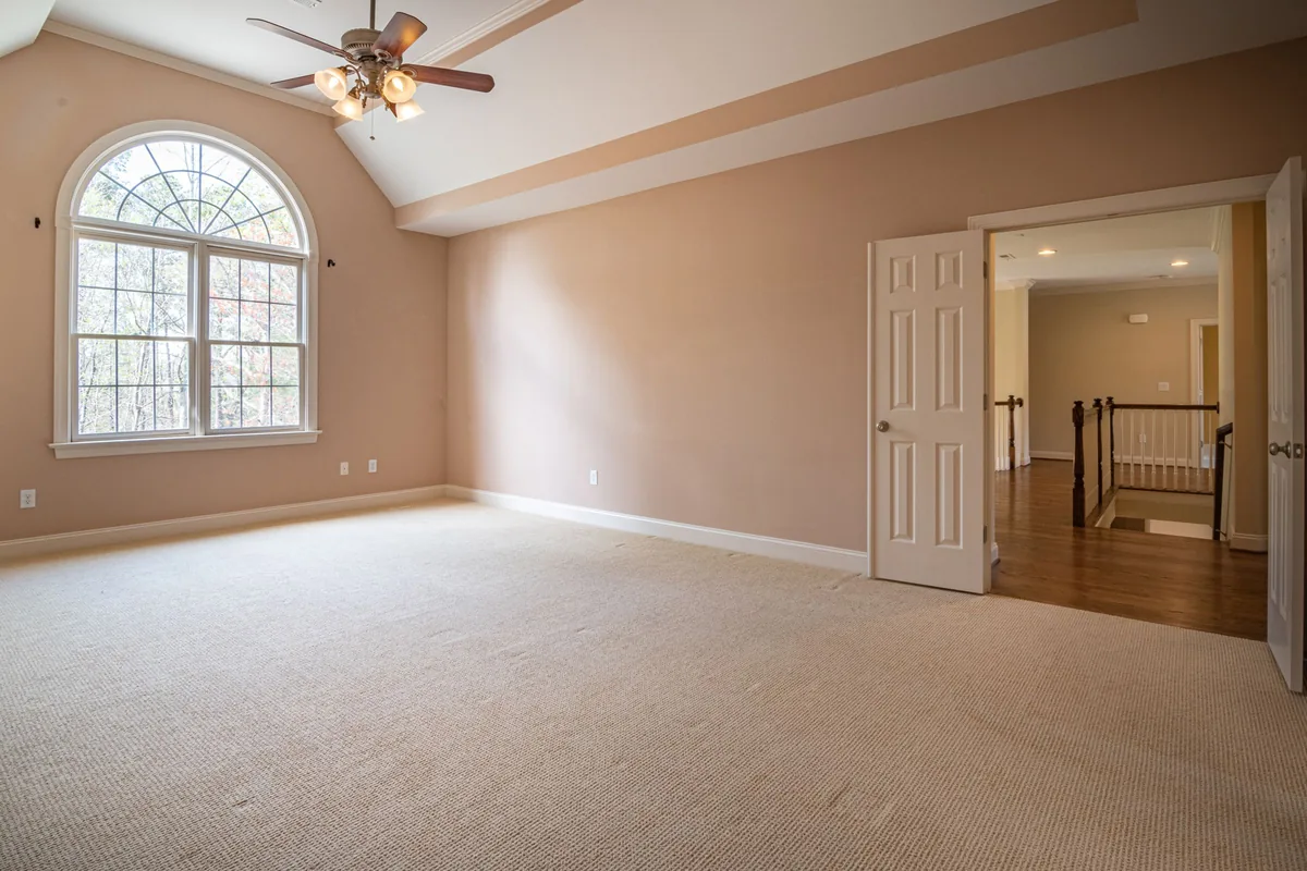 Bright empty room beige walls carpet flooring large
